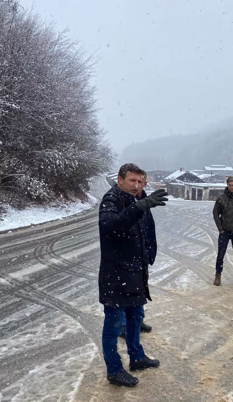 Kleurenfoto. Een man staat iets te vertellen.